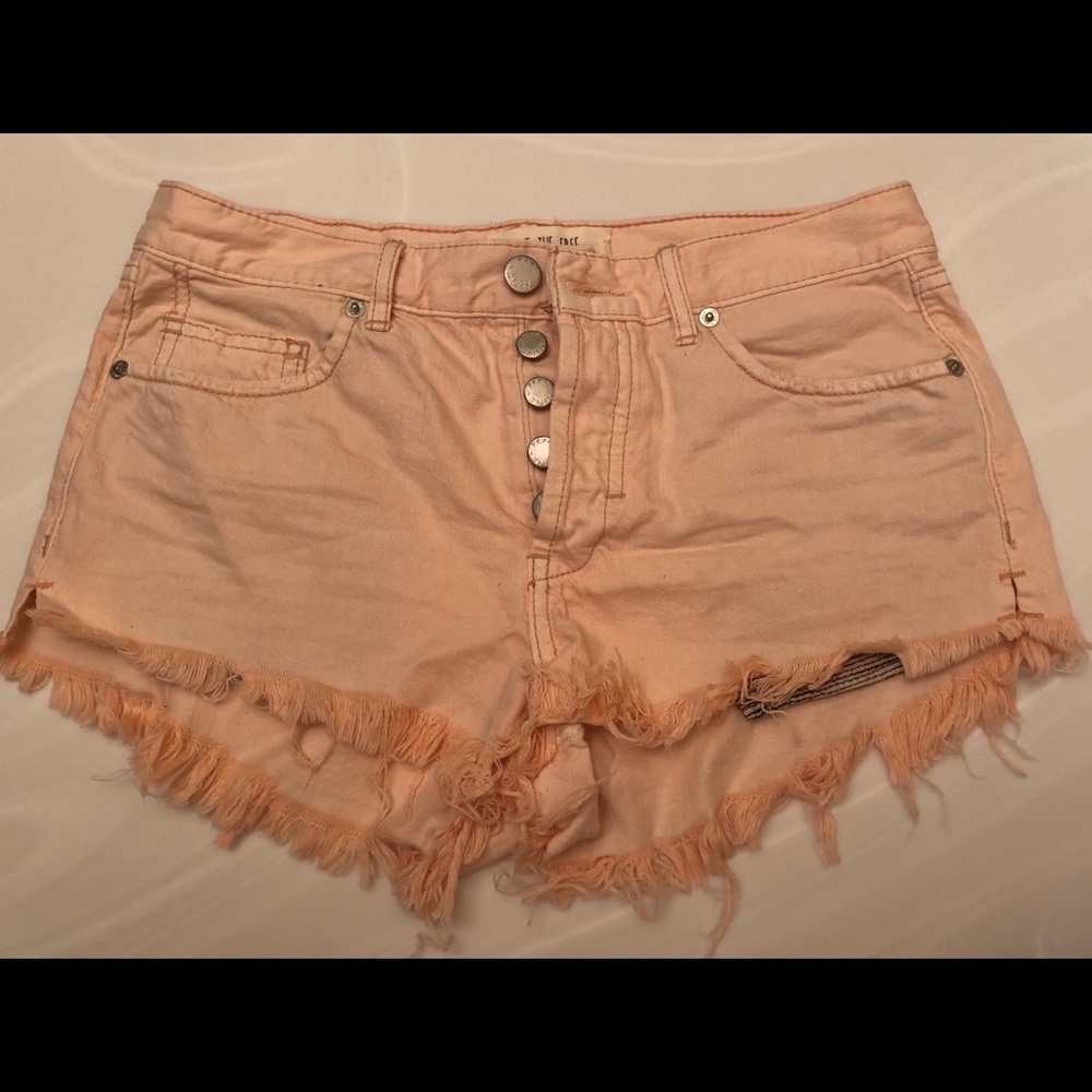 Salmon colored button up cutoff shorts